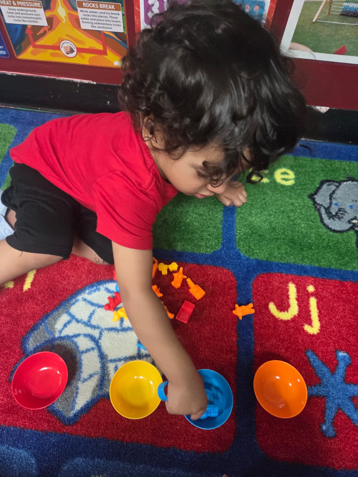 Toddlers playing in a bright classroom at Kindercity Champions Houston childcare.