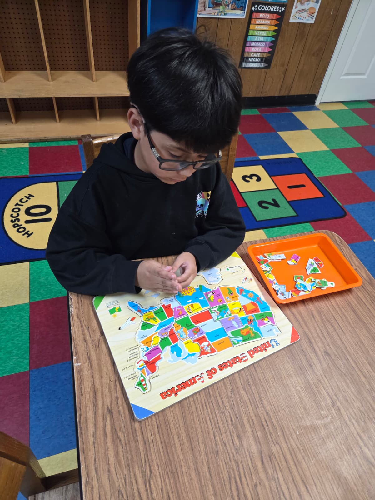 School-age children doing homework with support at Kindercity Champions after school program Houston.